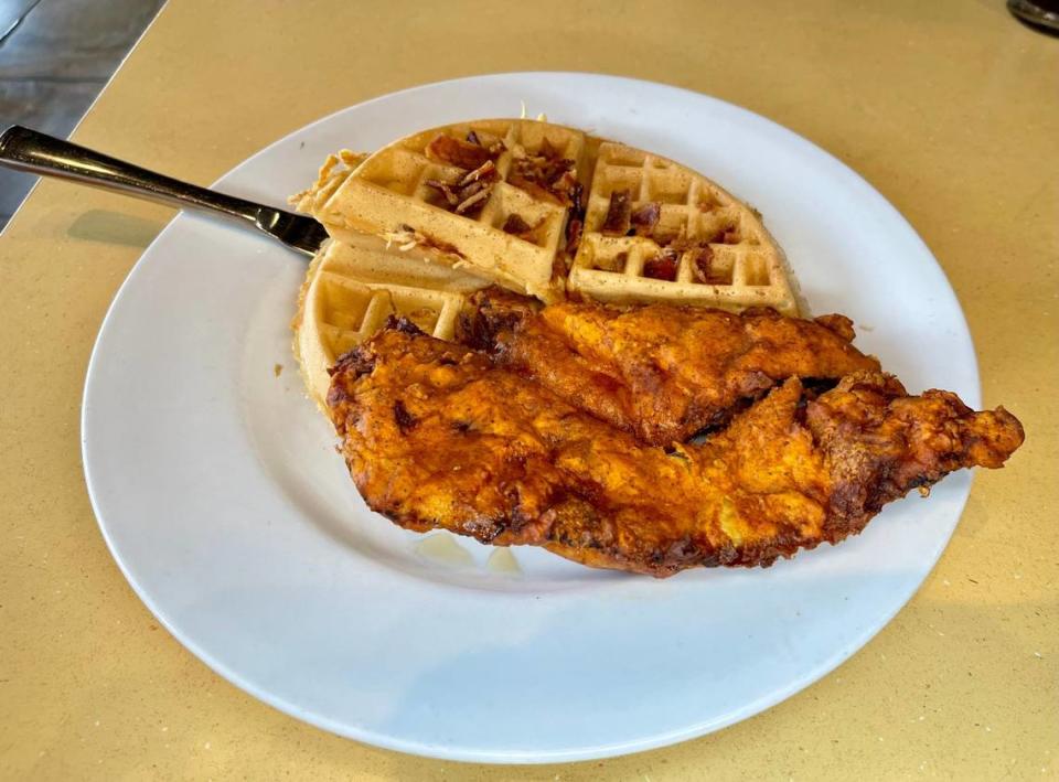 Wild Eggs offers seasoned chicken-infused waffle, Nashville Hot chicken breast, chopped bacon, and house-made buttermilk maple syrup.