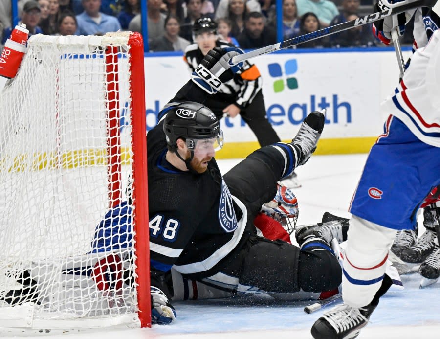Tampa Bay Lightning defenseman Nick Perbix (48) collides with Montreal Canadiens goaltender Cayden Primeau during the second period of an NHL hockey game Saturday, March 2, 2024, in Tampa, Fla. (AP Photo/Jason Behnken)