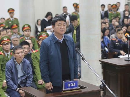 Vietnam's Communist Party Politburo former member and former chairman of PetroVietnam Dinh La Thang (front) stands as PVC's former chairman Trinh Xuan Thanh (L) sits at the court in Hanoi, Vietnam January 8, 2018. VNA/Doan Tan via REUTERS