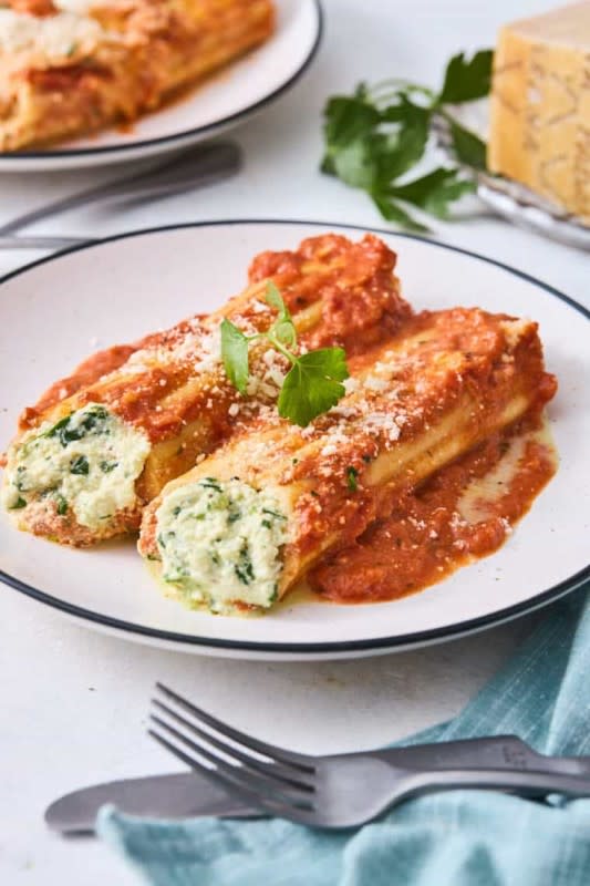 <p>Grandbaby Cakes</p><p>This Cheese Manicotti with Spinach is a creamy ricotta-filled pasta coated in a creole-seasoned sauce and marinara sauce that’s cheesy and absolutely delicious!</p><p><strong>Get the recipe: <a href="https://grandbaby-cakes.com/cheese-manicotti-with-spinach/" rel="nofollow noopener" target="_blank" data-ylk="slk:Cheese Manicotti with Spinach;elm:context_link;itc:0;sec:content-canvas" class="link ">Cheese Manicotti with Spinach</a></strong></p>
