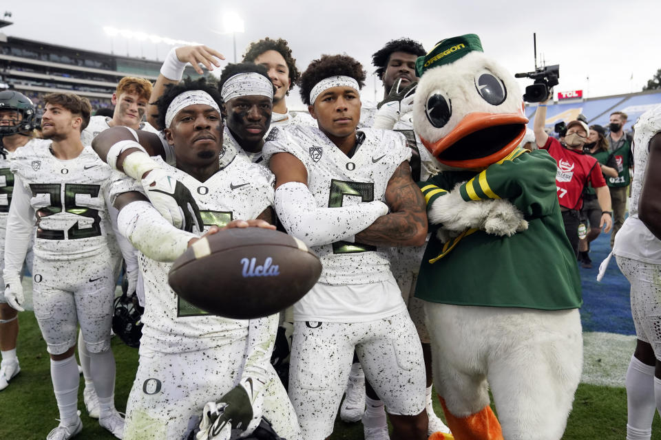 Oregon players and mascot celebrate a win over UCLA in an NCAA college football game Saturday, Oct. 23, 2021, in Pasadena, Calif. (AP Photo/Marcio Jose Sanchez)