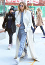 <p>The top model donned a sidewalk-grazing white coat, grey jumpsuit, and statement sunglasses while having lunch in the Big Apple.</p>