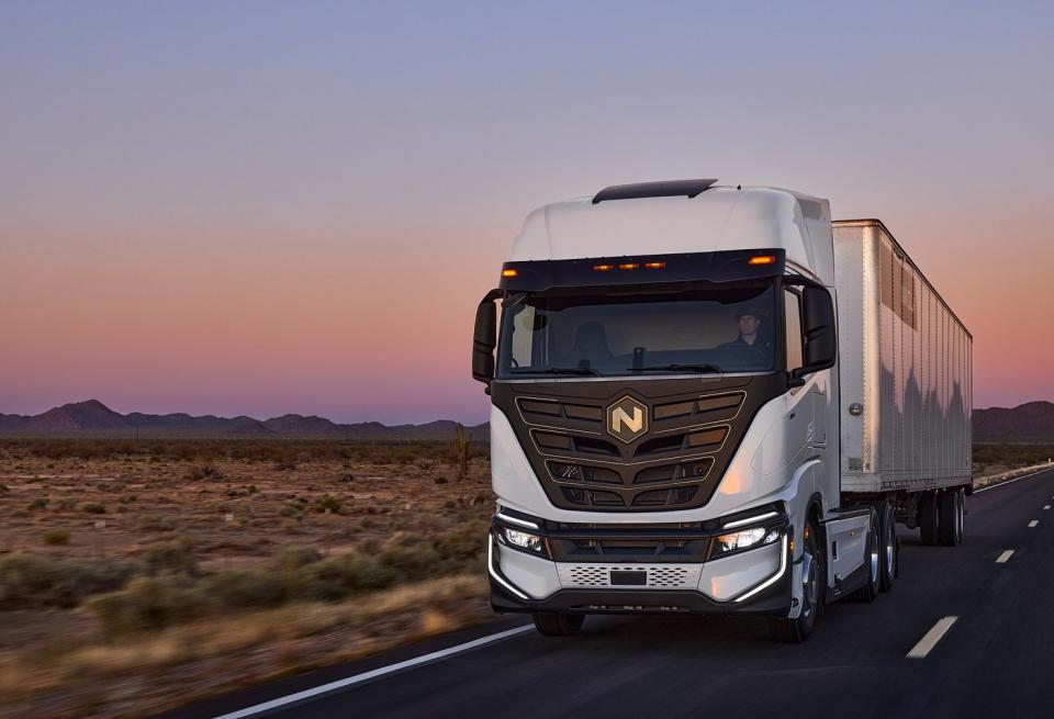 A Nikola Tre battery electric truck driving down a highway. 