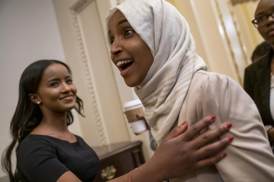 Rep. Ilhan Omar, D-Minn., a target of racist rhetoric from President Donald Trump, smiles as she is greeted at the Capitol following votes, in Washington, Thursday, July 18, 2019. (AP Photo/J. Scott Applewhite)