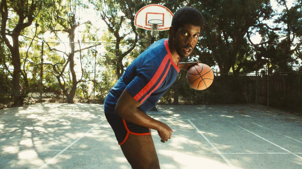 Quincy Isaiah as Magic Johnson dribbling a basketball in Winning Time