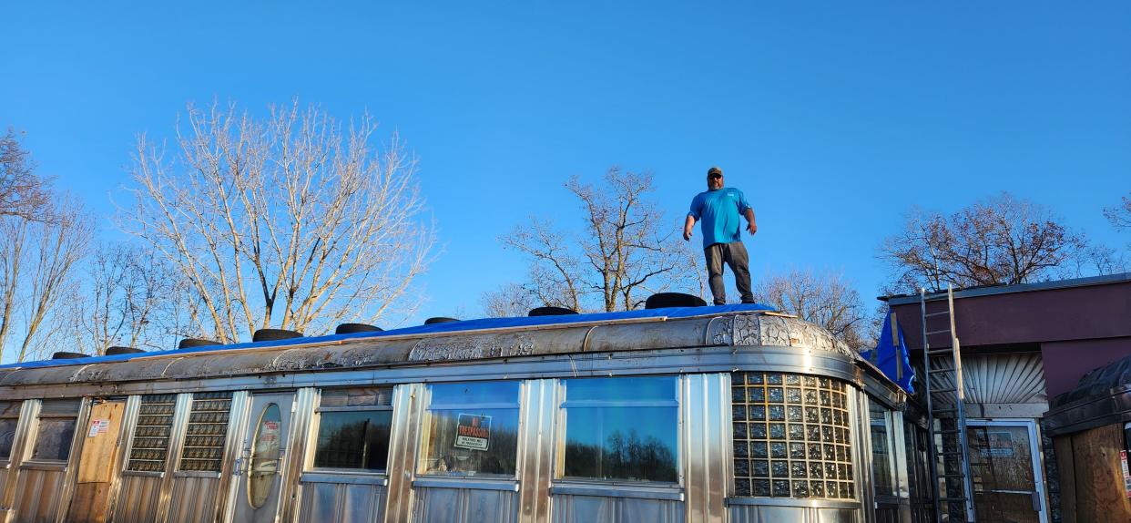 Chuck Perry fixing the roof of Rosie's.