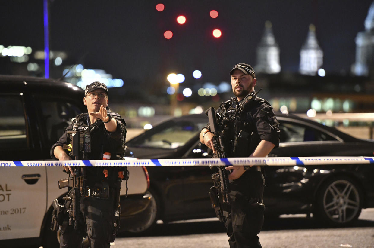 Armed Police officers stand guard on London Bridge in central London, Saturday, June 3, 2017. A series of attacks on London Bridge and nearby Borough Market in the heart of the British capital Saturday, as witnesses reported a vehicle veering off the road and hitting several pedestrians. (Dominic Lipinski/PA via AP)