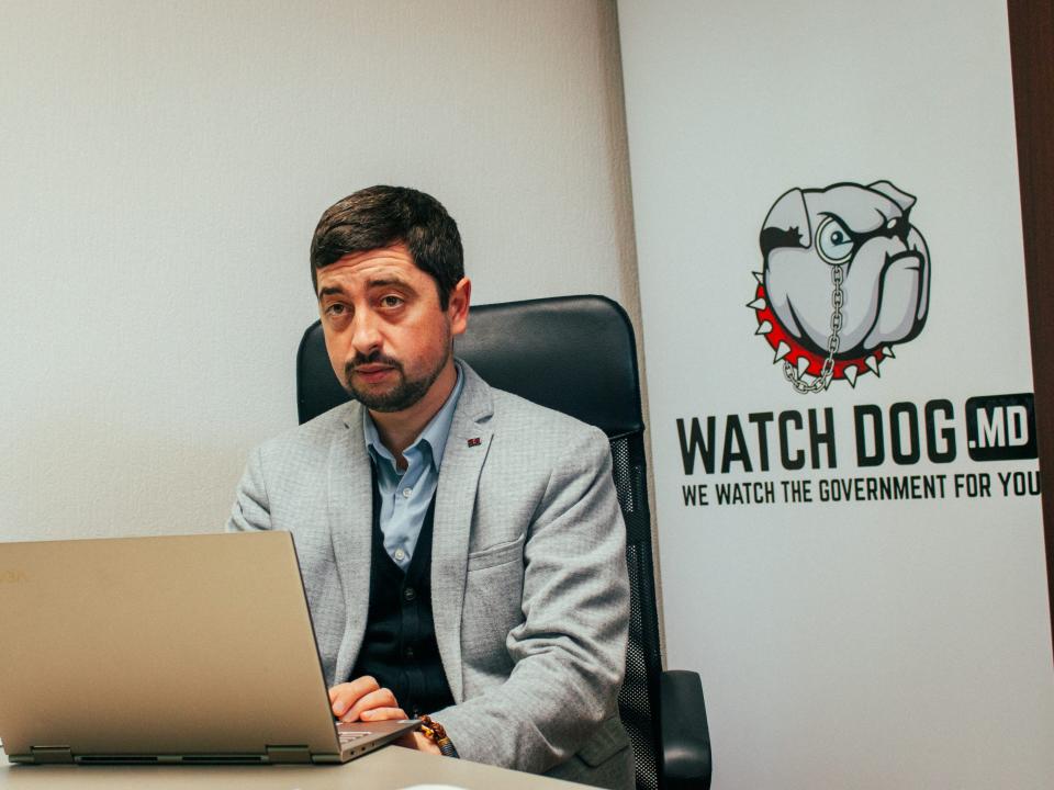 Valeriu Pasa sitting at a desk behind a laptop