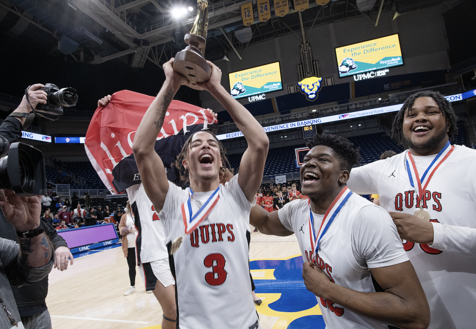 Aliquippa's DJ Walker holds up the WPIAL Class 2A basketball championship after Aliquippa defeated Northgate Saturday at the Petersen Events Center.