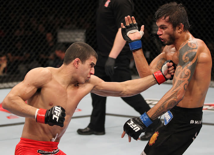 BELO HORIZONTE, BRAZIL - JUNE 23: (L-R) Felipe Arantes delivers a punch to the body of Milton Vieira during their UFC 147 featherweight bout at Estadio Jornalista Felipe Drummond on June 23, 2012 in Belo Horizonte, Brazil.