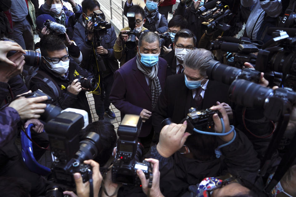 Hong Kong pro-democracy activist and media tycoon Jimmy Lai, center, arrives the Court of Final Appeal in Hong Kong, Thursday, Dec. 31, 2020. Hong Kong government prosecutors appeal against the bail granted to Lai. Lai was granted bail on Dec 23, nearly three weeks after he was remanded in custody over fraud and national security-related charges. (AP Photo/Kin Cheung)