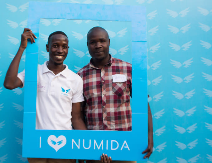 Two business people using Numida