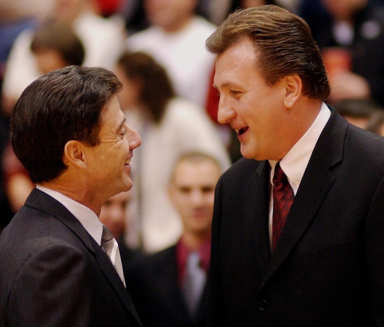 Louisville Cardinals head coach Rick Pitino talks with UC head coach Bob Huggins before the start of their game inside of the Shoemaker Center on Jan 19, 2002.