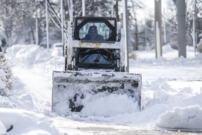 A tractor clears a walkway on the Drake University Campus in Des Moines, Iowa, earlier this week. Photo by Tannen Maury/UPI