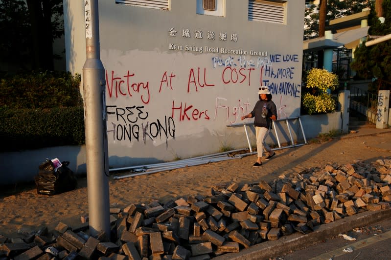 Volunteers clear away bricks from a road near Hong Kong's Baptist University