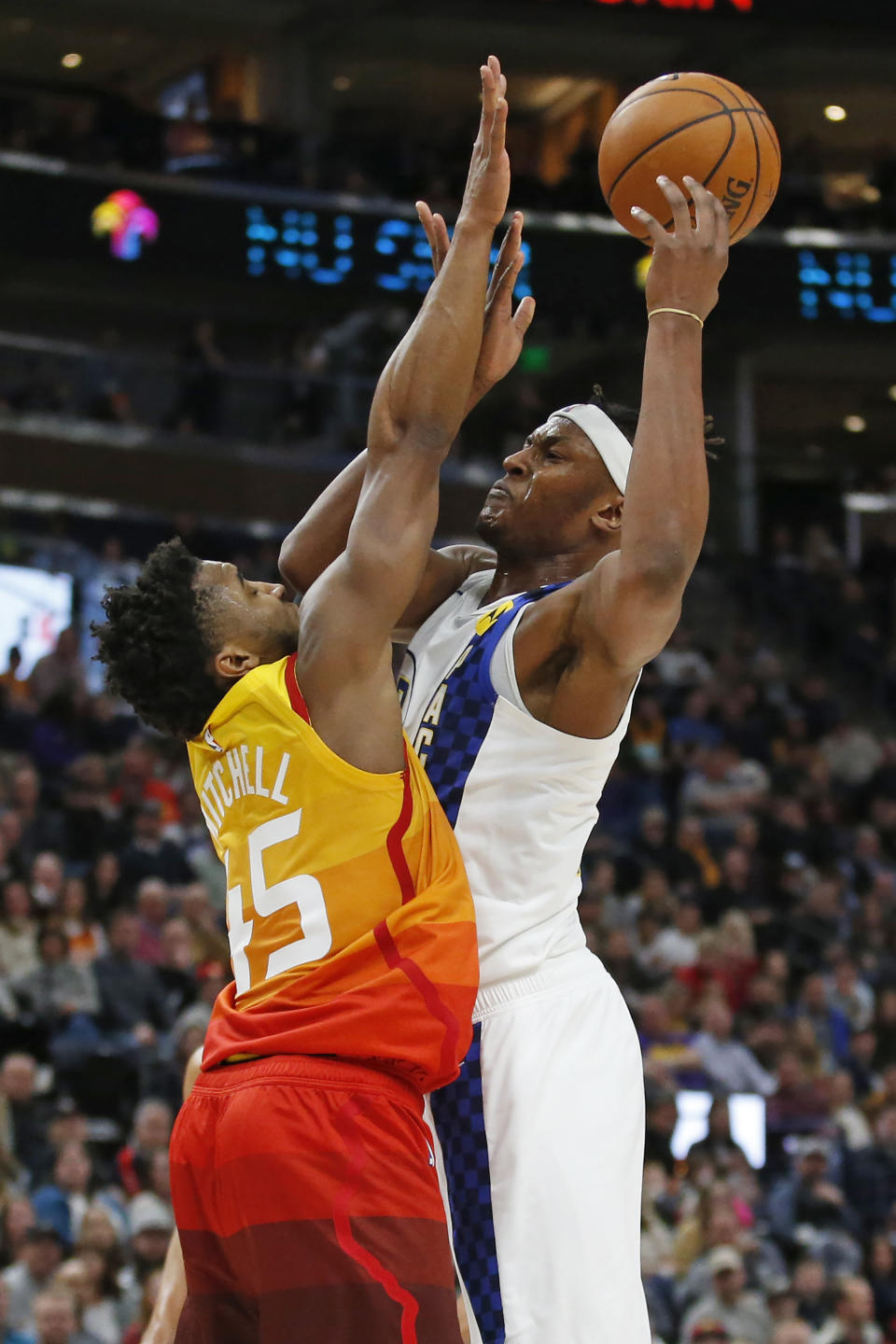 Utah Jazz guard Donovan Mitchell (45) defends against Indiana Pacers center Myles Turner, right, in the first half of an NBA basketball game Monday, Jan. 20, 2020, in Salt Lake City. (AP Photo/Rick Bowmer)