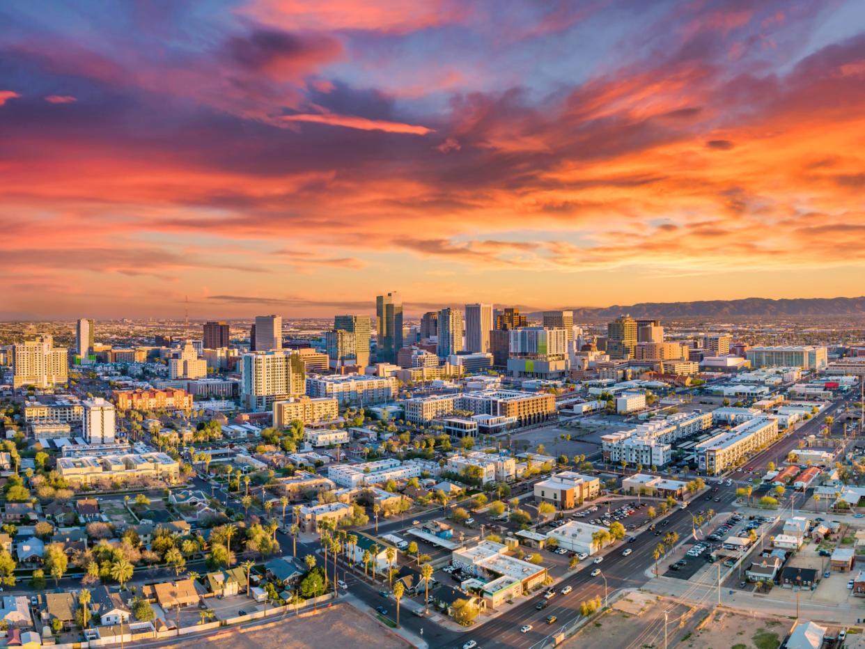 An aerial view of a city at sunset.