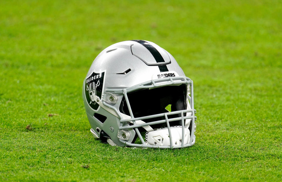 Dec 26, 2020; Paradise, Nevada, USA; A Las Vegas Raiders helmet rest on the football field before a game against the Miami Dolphins at Allegiant Stadium. Mandatory Credit: Kirby Lee-USA TODAY Sports