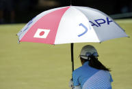 Mone Inami, of Japan, lines up a putt on the 13th hole during the third round of the women's golf event at the 2020 Summer Olympics, Friday, Aug. 6, 2021, at the Kasumigaseki Country Club in Kawagoe, Japan. (AP Photo/Matt York)