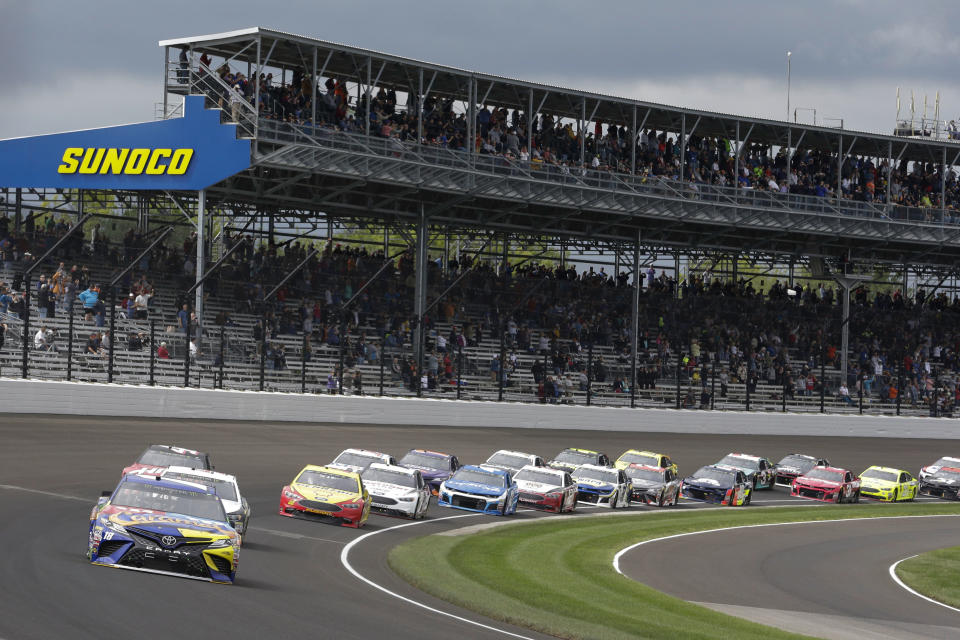 NASCAR Cup Series driver Kyle Busch (18) leads the first lap during the NASCAR Brickyard 400 auto race at Indianapolis Motor Speedway, in Indianapolis Monday, Sept. 10, 2018. (AP Photo/AJ Mast)