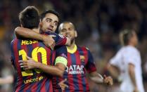 Barcelona's Lionel Messi (L) is congratulated by team mates Xavi (C) and Dani Alves after scoring his second goal against AC Milan during their Champions League soccer match at Nou Camp stadium in Barcelona November 6, 2013. REUTERS/Gustau Nacarino (SPAIN - Tags: SPORT SOCCER)