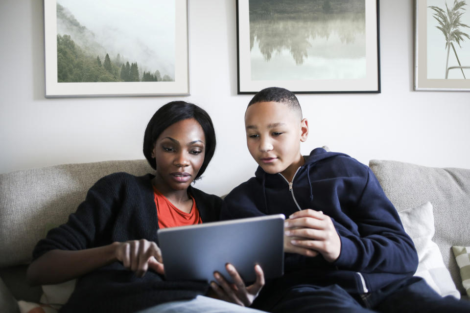 Mother and son looking at a tablet together