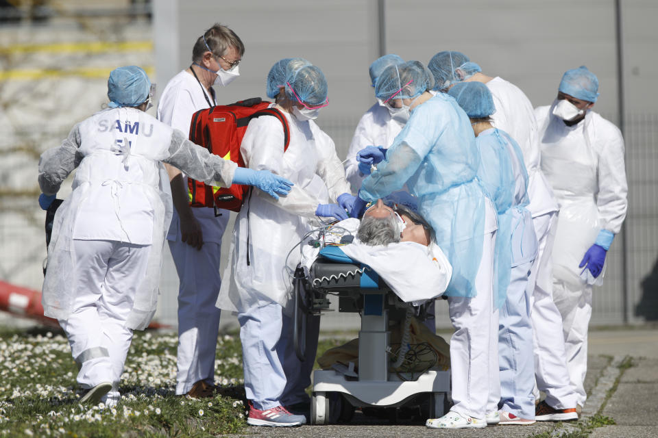 A victim of the Covid-19 virus is evacuated from the Mulhouse civil hospital, eastern France, Monday March 23, 2020. The Grand Est region is now the epicenter of the outbreak in France, which has buried the third most virus victims in Europe, after Italy and Spain. For most people, the new coronavirus causes only mild or moderate symptoms. For some it can cause more severe illness. (AP Photo/Jean-Francois Badias)