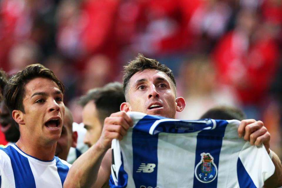 FC Porto’s Hector Herrera celebrates his late winner by holding up his jersey to the Benfica crowd. (EFE)