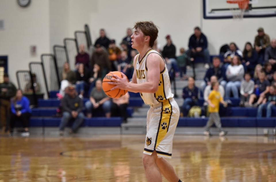 Ryland Randall looks for a teammate during the second half. Randall finished with eight points for the Wolves.