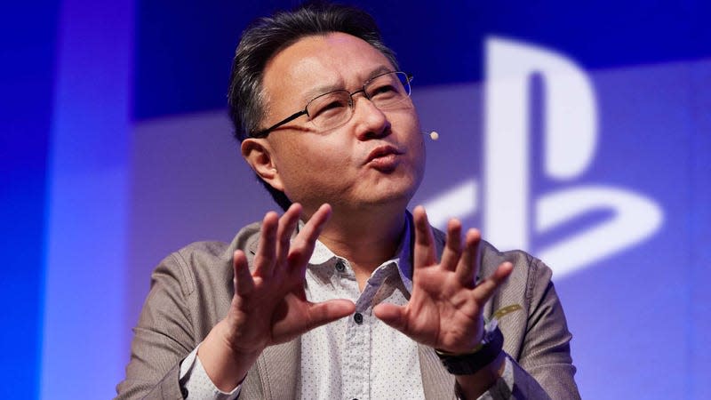 A photo shows Shuhei Yoshida talking in front of a blue wall and white PlayStation logo.