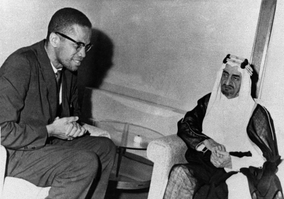 Malcolm X, left, African-American black muslim leader, is shown with King Faisal in Saudi Arabia in July 1964.