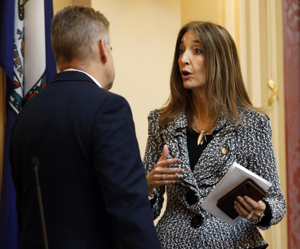 FILE - This Thursday Jan. 17, 2019 file photo shows Del. Eileen Filler-Corn, D-Fairfax, right, as she speaks with House speaker Kirk Cox, R-Colonial Heights, during the House session at the Capitol in Richmond, Va. Filler-Corn was selected by the new House Democratic majority as the new speaker of the House. (AP Photo/Steve Helber)