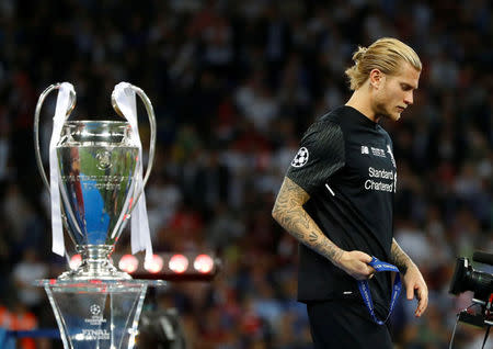 Soccer Football - Champions League Final - Real Madrid v Liverpool - NSC Olympic Stadium, Kiev, Ukraine - May 26, 2018 Liverpool's Loris Karius walks past the trophy with his medal after the match REUTERS/Kai Pfaffenbach