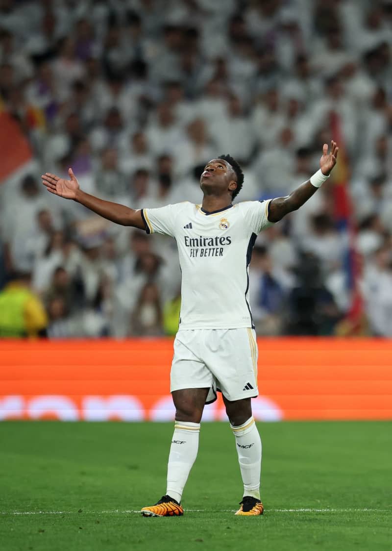 Real Madrid's Vinicius Junior celebrates scoring his side's first goal during the UEFA Champions League round of 16 second leg soccer match between Real Madrid and RB Leipzig at Santiago Bernabeu Stadium. Jan Woitas/dpa