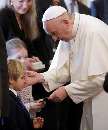 Pope Francis smiles to a boy (L) during a private audience with Liechtenstein Royal Family at the Vatican, April 22, 2017. REUTERS/Alessandra Tarantino/Pool