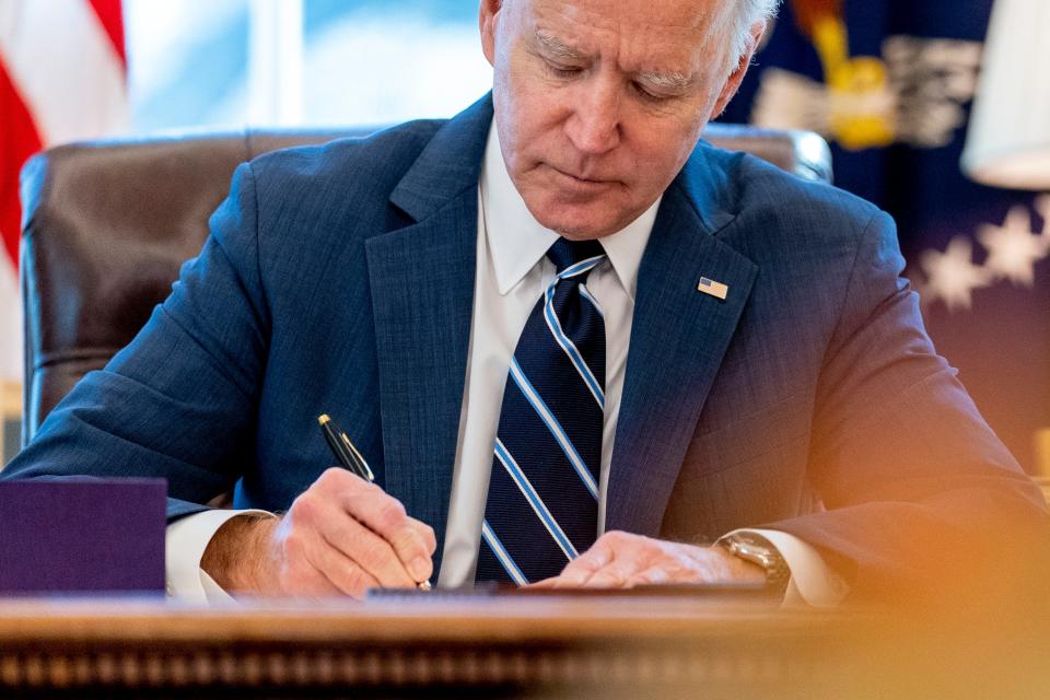 President Joe Biden signs the American Rescue Plan, a coronavirus relief package, in the Oval Office of the White House, Thursday, March 11, 2021, in Washington.