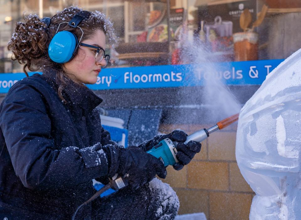 Nalia Warmack makes the ice fly as she works on her ice sculpture outside Cornucopia Kitchen Shop during last year's Fire & Ice carving competition and festival in Sturgeon Bay. Warmack won first place with her carving of a girl with rain gear and umbrella feeding a goose.