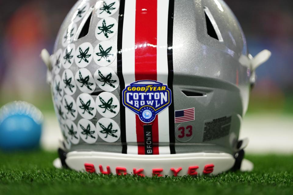 Dec 29, 2023; Arlington, Texas, USA; The helmet of Ohio State Buckeyes quarterback Devin Brown (33) sits on the sideline prior to the Goodyear Cotton Bowl Classic against the Missouri Tigers at AT&T Stadium.