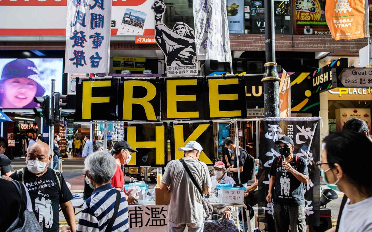 A sign reading FREE HK with the 'Goddess of Democracy' (C) is displayed near Victoria Park in Hong Kong -  ANTHONY WALLACE/AFP