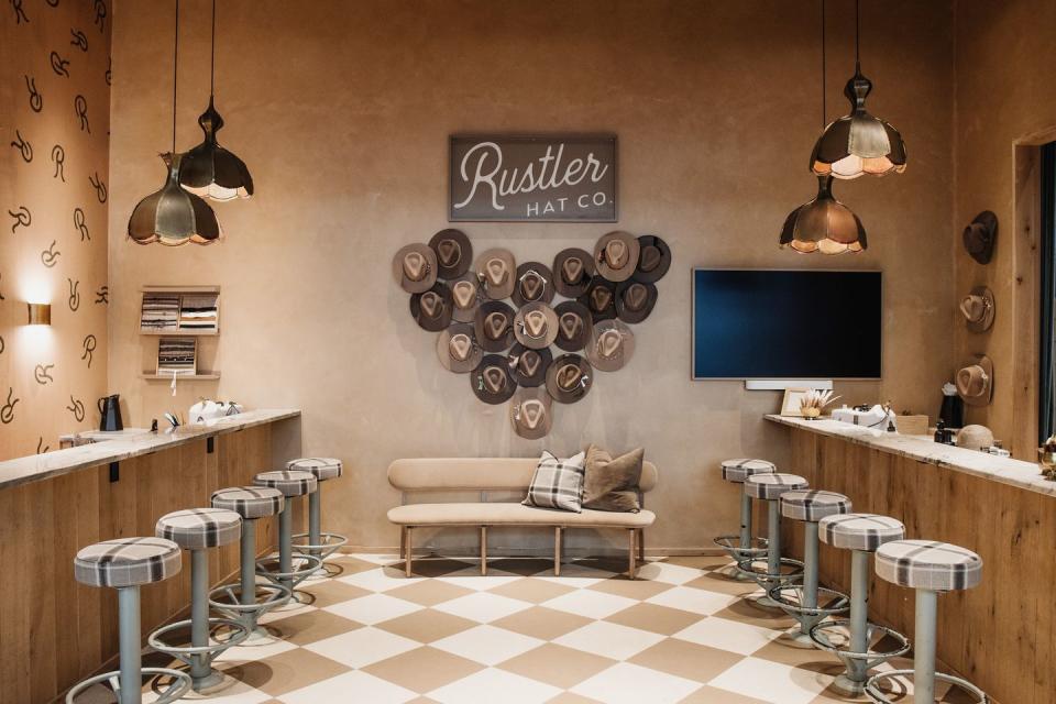a room with stools in Rustler Hat Co