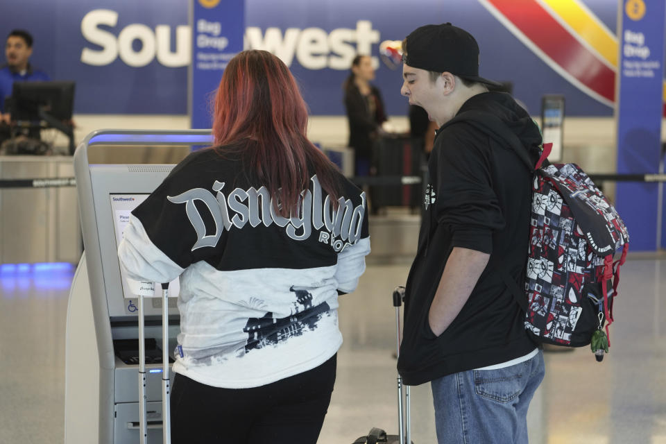 Passengers check-in at Southwest on Wednesday, Nov. 22, 2023, at Los Angeles International Airport in Los Angeles. The late crush of holiday travelers is picking up steam, with about 2.7 million people expected to board flights on Wednesday and millions more planning to drive or take the train to Thanksgiving celebrations. (AP Photo/Damian Dovarganes)