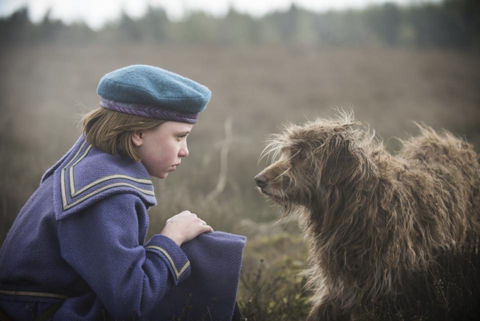 Dixie Egerickx with a dog in "The Secret Garden."