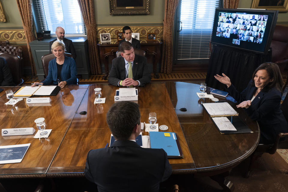 FILE - In this May 13, 2021, file photo Vice President Kamala Harris, right, greets attendees of the inaugural meeting of the Task Force on Worker Organizing and Empowerment, with in-person attendees including Energy Secretary Jennifer Granholm, back left, Labor Secretary Marty Walsh, and Transportation Secretary Pete Buttigieg, front, in Harris' ceremonial office on the White House complex in Washington. The Centers for Disease Control and Prevention said Thursday that fully vaccinated people — those who are two weeks past their last required dose of a COVID-19 vaccine — can stop wearing masks outdoors in crowds and in most indoor settings. Across Washington, the government is adjusting in a variety of ways to new federal guidance easing up on when face masks should be worn. (AP Photo/Jacquelyn Martin, File)