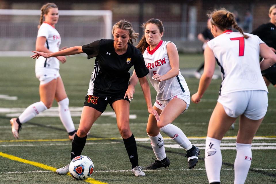 Rocky Mountain girls soccer player Jace Holley tries to navigate by Fairview defenders during the 5A quarterfinals at Trailblazer Stadium in Lakewood, Colo., on Monday, May 15, 2023. The Lobos lost 2-0.