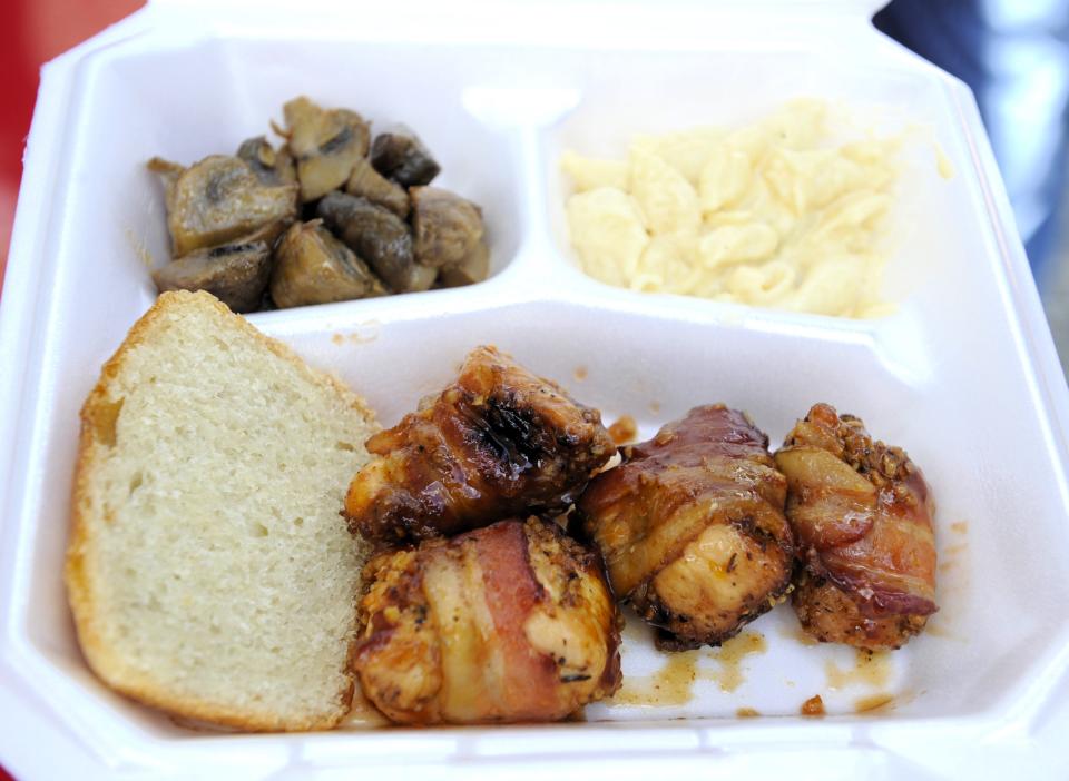 Hillbilly Chicken Bites are chunks of chicken breast wrapped in bacon, and smoked with a glaze of barbecue sauce. They are served with homemade sourdough bread, Andy's mushroom  and a side of mac n cheese from the Shortstacks Kitchen truck on Sunday, Sept. 10, 2023.