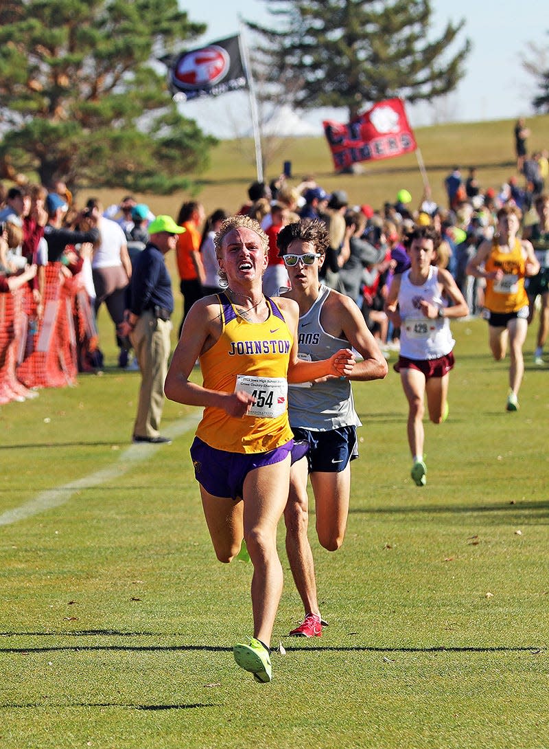 Johnston senior Jaxson Plumb (454) flies down the home stretch during the State Cross Country Class 4A Boys 5K race at the Lakeside Municipal Golf Course in Fort Dodge.