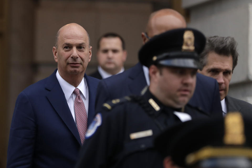 U.S. Ambassador to the European Union Gordon Sondland, left, leaves after testifying before the House Intelligence Committee on Capitol Hill in Washington, Wednesday, Nov. 20, 2019, during a public impeachment hearing of President Donald Trump's efforts to tie U.S. aid for Ukraine to investigations of his political opponents. (AP Photo/Julio Cortez)