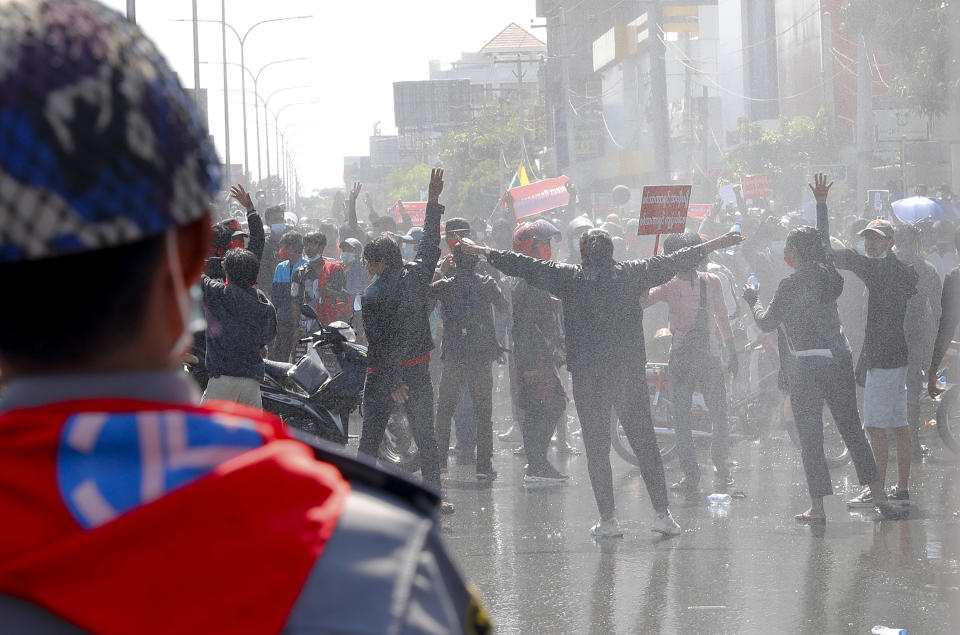 Protesters regroup after police fired warning-shots and use water cannons during a protest in Mandalay, Myanmar on Tuesday, Feb. 9, 2021. Police cracked down Tuesday on the demonstrators protesting against Myanmar’s military takeover who took to the streets in defiance of new protest bans. (AP Photo)