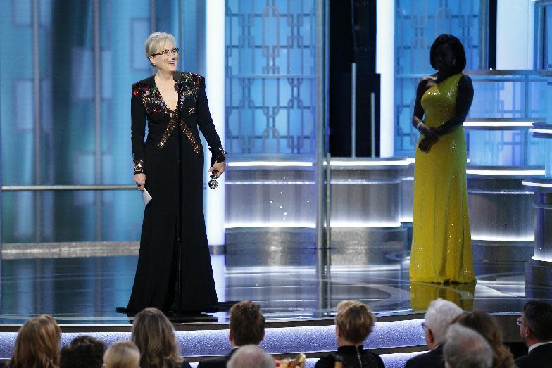 This image released by NBC shows Meryl Streep accepting the Cecil B. DeMille Award as presenter Viola Davis, right, looks on, at the 74th Annual Golden Globe Awards at the Beverly Hilton Hotel in Beverly Hills, Calif., on Sunday, Jan. 8, 2017. (Paul Drinkwater/NBC via AP)