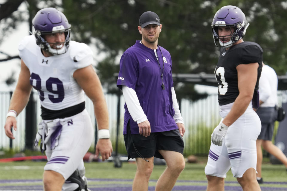 Northwestern interim head coach David Braun, center, watches players during team's practice in Evanston, Ill., Wednesday, Aug. 9, 2023. (AP Photo/Nam Y. Huh)